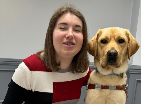 Kortnee and yellow Lab guide dog Ada sit for their team portrait