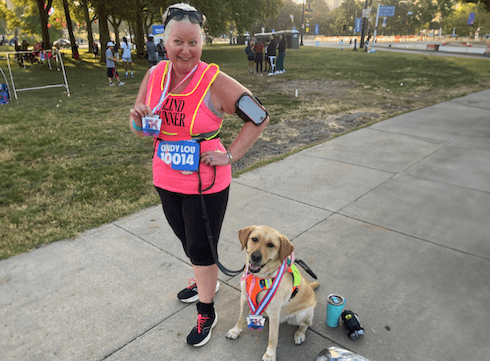 Cindy Lou in running garb and Crystal wearing their 5K tags